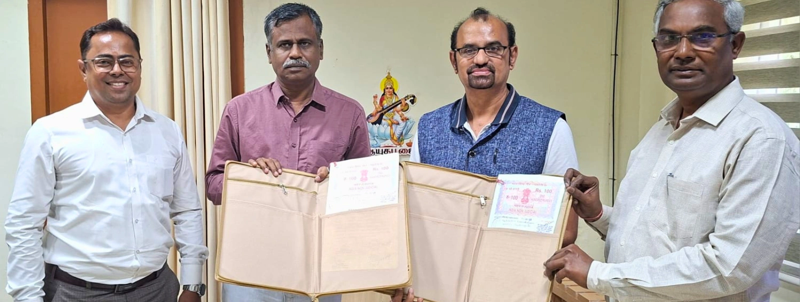 Four men display Bharathidasan University diploma in film technology course in Chennai at a film academy in Tamil Nadu.