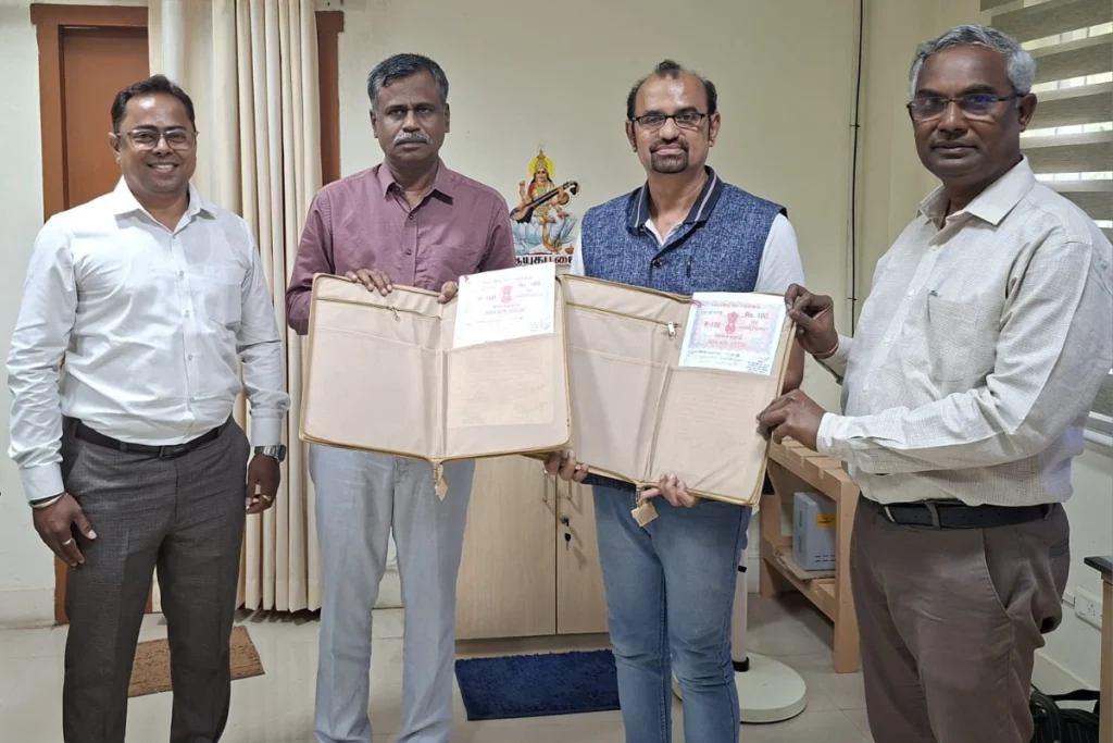 Four men display Bharathidasan University diplomas in film technology courses at a film academy in Chennai, Tamil Nadu.